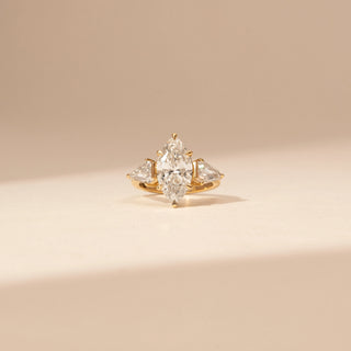 Front view of a 14KT Yellow Gold diamond ring with a marquise centre diamond, pear-shaped side diamonds and baguette accents.