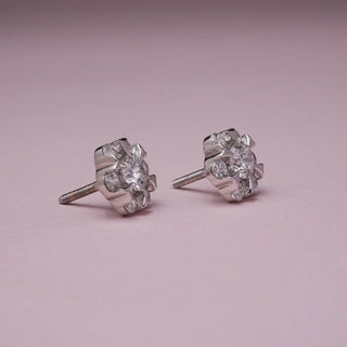 Side angle view of Elegant Flower Diamond Stud Earrings in 14KT White Gold, featuring EF VVS round diamonds in a radiant floral cluster design with screw-back closure.