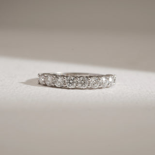 Front view of Minimalist 9-Stone Diamond Ring against beige background. Designed in 14KT hallmarked white gold, size 12, adorned with EF colour, VVS clarity lab grown diamonds weighing a total of 1 carat. Ring weighs 2.85 grams, priced INR 50,000–1,00,000.