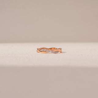 Front view of an intertwined diamond ring in 14KT rose gold, featuring pavé-set diamonds and a graceful crossover design.