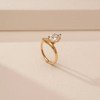 Angled view of Elegant Pear Twist Diamond Ring in 14KT Yellow Gold, featuring a pear-cut lab-grown diamond.