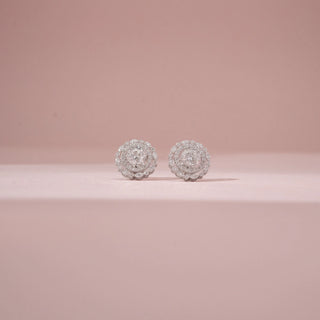 Front view of a 14KT White Gold diamond stud earrings, featuring round diamonds in a floral halo setting.