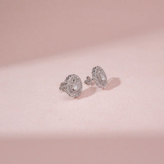 Side view of a 14KT White Gold diamond stud earrings, featuring round diamonds in a floral halo setting.