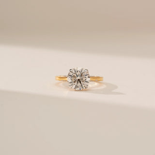 Front view of Radiant Rounded Solitaire Ring in 14KT Yellow Gold, featuring a round brilliant lab-grown diamond against a beige backdrop.