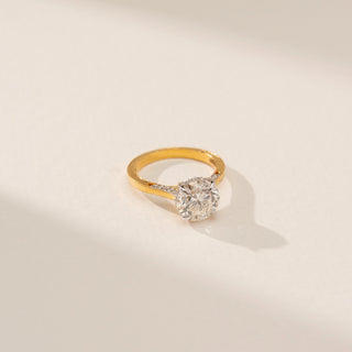Top view of Radiant Rounded Solitaire Ring in 14KT Yellow Gold, featuring a round lab-grown diamond against a beige backdrop.
