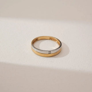 Top view of Sleek Flush Set Diamond Band in dual gold, featuring a single round lab-grown diamond embedded flush within a smooth polished band, displayed on a soft neutral background.