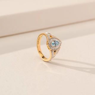 Angled view of Radiant Blue Pear Halo Diamond Ring in 14KT Yellow Gold, featuring a blue pear lab-grown diamond with a halo.