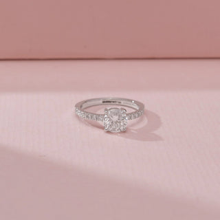 Close up view of a 14KT White Gold diamond ring, featuring a cushion-cut centre diamond and diamond-set shoulders.