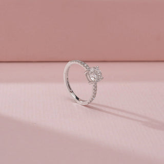 Angled view of a 14KT White Gold diamond ring, featuring a cushion-cut centre diamond and diamond-set shoulders.