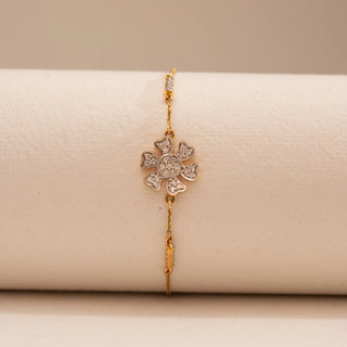 Front view of Reia’s 14 KT Yellow Gold Delicate Floral Gold Diamond Bracelet. Captured on a white display, it highlights the architectural floral motif and brilliant round diamonds.
