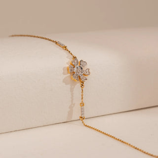 Side view of Reia’s 14 KT Yellow Gold Delicate Floral Gold Diamond Bracelet. The layout highlights the floral centrepiece and bar accents set with brilliant diamonds on a slender chain.
