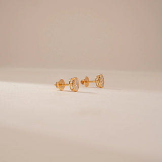Side view of a 14KT Yellow Gold diamond stud earrings, featuring oval diamonds in a bezel setting.