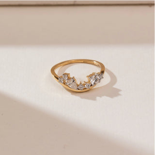 Top view of Curved Tiara Crown Diamond Band in yellow gold, featuring a pear-shaped lab-grown diamond with graduated round diamond accents forming a crown-like curved silhouette, displayed on a beige backdrop.