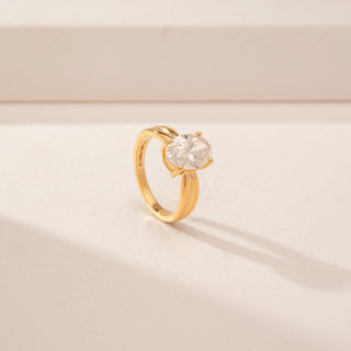 Angled view of a 14KT Yellow Gold diamond ring, featuring an oval-cut centre diamond and a double-band design.