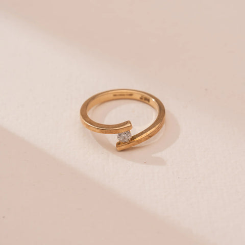 Top view of  Soft Arc Diamond Open Ring in 14KT Yellow Gold, featuring a centred round lab-grown diamond between softly curved open arms. Captured against a beige backdrop, the fluid arc design highlights minimalism and subtle sparkle.