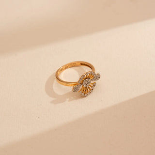 Top-down view of Reia’s 14 KT Yellow Gold Intricate Floral Mandala Diamond Ring. Captured on a cream backdrop, it highlights the architectural petals and sun-like rays set with brilliant diamonds.