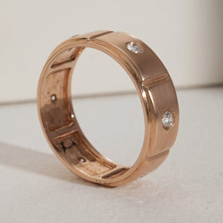 Front side-angle view of a men’s rose gold diamond ring in hallmarked 14KT gold, showcasing embedded round-cut lab grown diamonds of EF colour and VVS clarity. The polished rose gold surface is accented with evenly spaced diamond settings, giving a bold yet refined masculine appeal.
