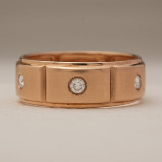 Front view of a men’s rose gold diamond ring crafted in 14KT gold, featuring round-cut EF VVS lab grown diamonds embedded in rectangular partitions along the band. The symmetry of the design highlights the ring’s contemporary elegance and strong masculine character.