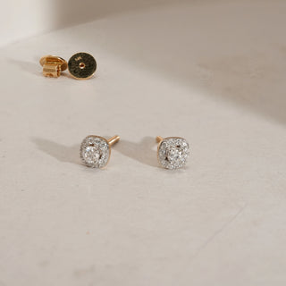 Pair of Halo Solitaire Diamond Stud Earrings displayed upright, showcasing the cushion-shaped diamond halo. The earrings are made in yellow gold with 14KT hallmarked purity, featuring EF colour, VVS clarity diamonds with a 0.45 carat solitaire each, and a total diamond weight of 1.116 carats.