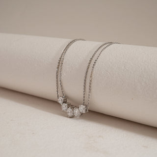 Side view of Five-Stone Sparkler Diamond Necklace on beige background. Made in 14KT hallmarked white gold, size 14, featuring EF colour, VVS clarity lab grown diamonds totaling 2.54 carats, with a 0.62-carat solitaire. Product weighs 5.57 grams, designed for lasting brilliance.