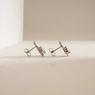 Side view of Pear Halo Drop Diamond Earrings against beige background. Designed in 14KT hallmarked white gold, featuring EF colour, VVS clarity lab grown diamonds totaling 0.94 carats, solitaire 0.34 carats. Weight 2.07 grams, with push-pull closure. Price range INR 50,000–1,00,000.