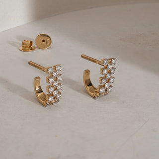 Radiant Arc Channel Diamond Earrings in 18KT Yellow Gold, designed with twin rows of sparkling round-cut diamonds and Bombay screw backs.