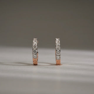 Front view of Gold Bloom Drop Diamond Earrings in 14KT Rose Gold, designed as sleek hoops encrusted with EF-VVS round lab-grown diamonds, displayed upright on a neutral background.