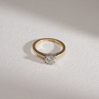 Antique Solitaire Gold Diamond Ring in 14KT hallmarked yellow gold, photographed on a grey textured surface. The design features a 0.73-carat solitaire diamond in EF colour, VVS clarity, prong-set at the centre, highlighted with a 0.86-carat total weight. Product size is 12, weighing 2.89 grams.