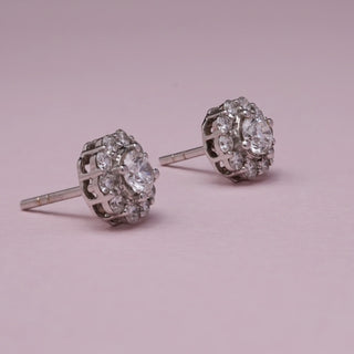 Side view of Classic Halo Diamond Stud Earrings in 14KT White Gold, featuring EF VVS round diamonds with a central stone and pavé-set halo, crafted for timeless elegance and radiant sparkle.