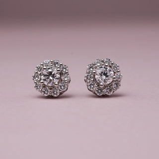 Front view of Classic Halo Diamond Stud Earrings in 14KT White Gold, featuring EF VVS round diamonds with a centre stone and halo cluster design, radiating timeless brilliance and elegance.