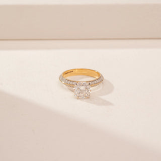 Front view of a 14KT Yellow Gold diamond ring with a round centre stone and pavé-set double band.