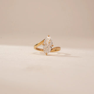 Front view of a 14KT Yellow Gold diamond ring, featuring an oval-cut centre diamond and a plain gold band.