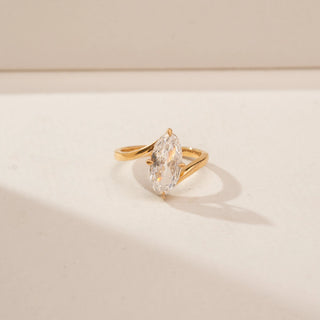 Close-up view of a 14KT Yellow Gold diamond ring, featuring an oval-cut centre diamond and a plain gold band.