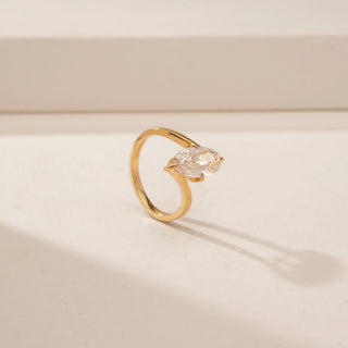 Angled view of a 14KT Yellow Gold diamond ring, featuring an oval-cut centre diamond and a plain gold band.