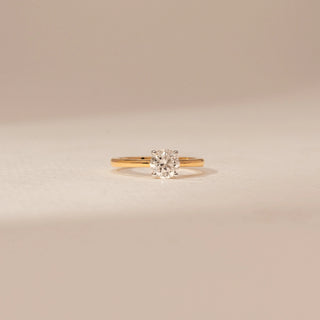 Front view of a 14KT Yellow Gold diamond ring, featuring a round centre diamond in a four-prong setting.