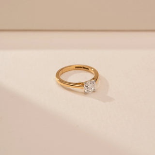 Side view of a 14KT Yellow Gold diamond ring, featuring a round centre diamond in a four-prong setting.