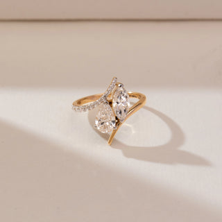 Front view of Marquise Pear Bypass Diamond Ring, 14KT yellow gold band featuring marquise and pear-shaped diamonds with pavé accents in a graceful bypass design.