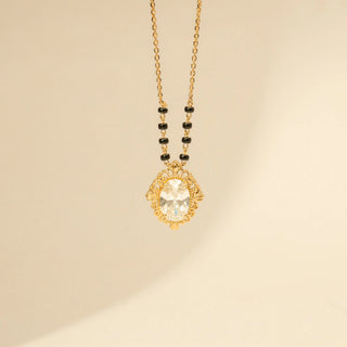 Close up view of Oval Diamond Mangalsutra Pendant in 14KT Yellow Gold, featuring an oval diamond and ornate vintage frame.