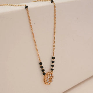 Close side view of yellow gold floral diamond mangalsutra pendant with round lab grown diamonds and black bead chain accents, highlighting the raised design and detailing.