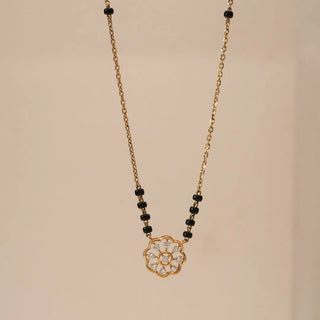 Front view of yellow gold floral diamond mangalsutra pendant with round lab-grown diamonds and black bead chain accents, showcasing a delicate flower motif on a minimal chain.


