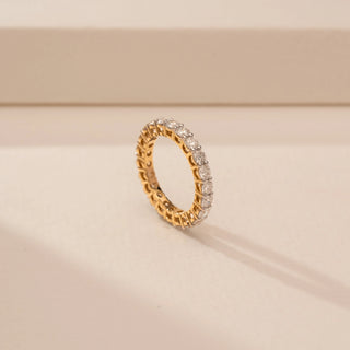 Angled view of Timeless Alternating Diamond Eternity Ring in 14KT Yellow Gold, featuring round-cut lab-grown diamonds.