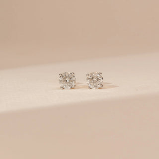 Front view of Pure Round Solitaire Diamond Earrings in 14KT Yellow Gold, featuring round brilliant-cut lab-grown diamonds.