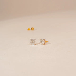 Angled view of Pure Round Solitaire Diamond Earrings in 14KT Yellow Gold, featuring round brilliant-cut lab-grown diamonds.
