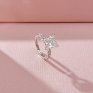 Angled view of Princess-Cut Solitaire Diamond Ring in 14KT White Gold, featuring a square-cut diamond and pavé-set band.
