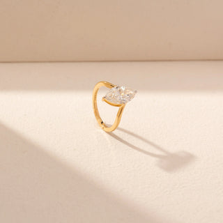 Angled view of Marquise Solitaire Diamond Ring in 14KT Yellow Gold, featuring a marquise-cut lab-grown diamond with a curved band.