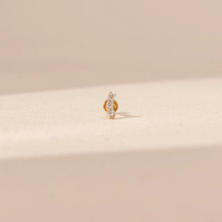 Front view of a diamond nose pin in 14KT yellow gold, featuring pavé-set round lab-grown diamonds and a curved design.