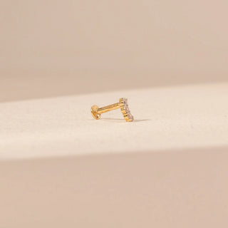Angled view of a diamond nosepin in 14KT yellow gold, featuring pavé-set round lab-grown diamonds on a curved hoop.
