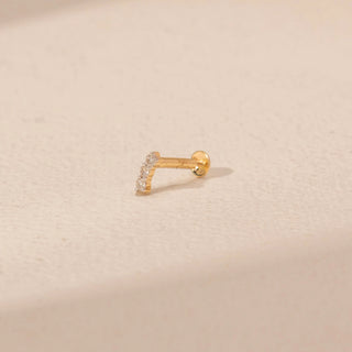 Side view of a 14KT yellow gold diamond nosepin with a curved row of pavé-set round lab-grown diamonds.