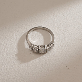 Top view of Modern Five Stone Diamond Engagement Ring on beige background. Crafted in 14KT hallmarked white gold, size 12, featuring EF colour, VVS clarity lab grown diamonds totaling 0.97 carats, including a 0.47-carat solitaire. Ring weighs 2.52 grams, priced INR 50,000–1,00,000.