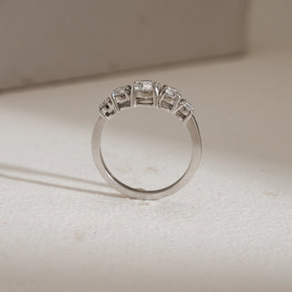 de view of Modern Five Stone Diamond Engagement Ring photographed on beige background. Made in 14KT hallmarked white gold, size 12, with EF VVS lab grown diamonds weighing 0.97 carats in total, solitaire 0.47 carats. Ring weighs 2.52 grams, priced INR 50,000–1,00,000.